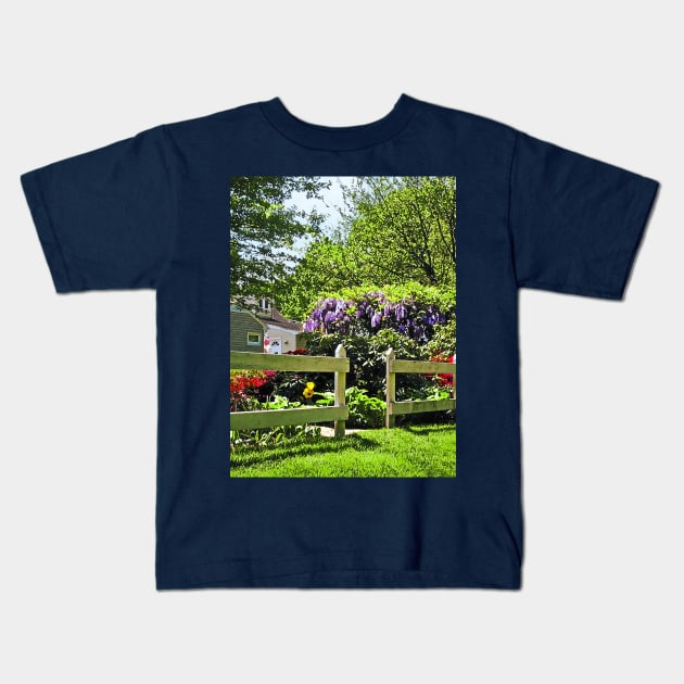 Spring Garden With Wisteria Kids T-Shirt by SusanSavad